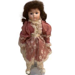 Vintage Heritage Mint Ltd porcelain doll
brunette ringlets blue eyes pink dress